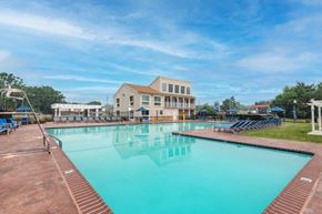 Glen Burnie apartment for rent - a large swimming pool with a building in the background