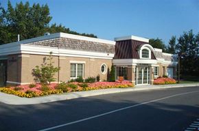 Cranston apartment for rent - a building with a flower garden in front of it