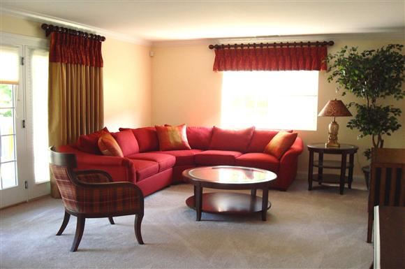 Cranston apartment for rent - a living room with a red couch and a table