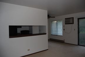 Lake Bluff apartment for rent - A room with a white wall and a brown shelf.