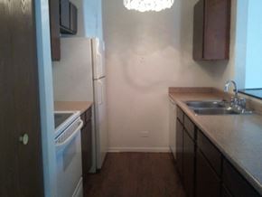 Lake Bluff apartment for rent - A kitchen with a white refrigerator and a white dishwasher.