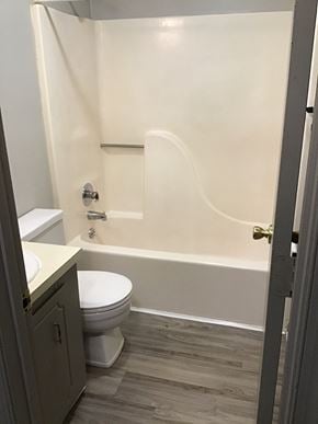 Kernersville apartment for rent - A white toilet sits next to a bathtub in a bathroom.