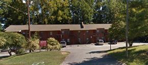 Kernersville apartment for rent - A building with a red sign in front of it.
