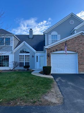 Gurnee apartment for rent - A house with a grey roof and a white garage door.