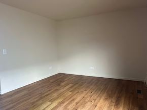 Gurnee apartment for rent - A room with wooden flooring and white walls.