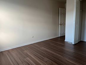 Gurnee apartment for rent - A room with wooden flooring and a white door.
