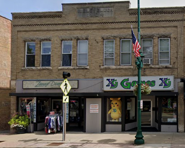 Gurnee apartment for rent - A street view of a building with a sign that says "XG Goods XG".