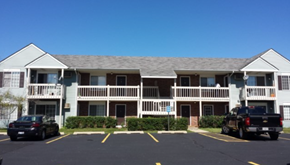 Grayslake apartment for rent - A building with a parking lot in front of it.