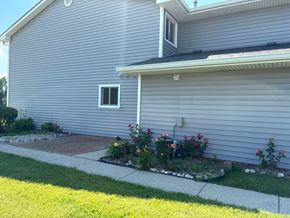 Gurnee apartment for rent - A house with a grey siding and a white gutter.