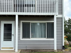 Gurnee apartment for rent - A grey house with a white door and a balcony.