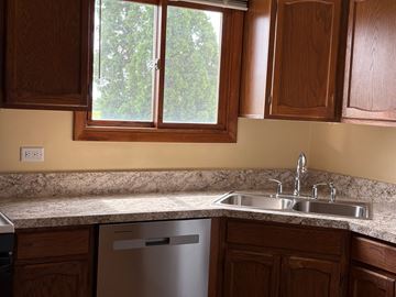 Gurnee apartment for rent - A kitchen with a dishwasher and a double sink.