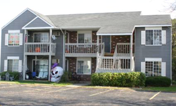 Grayslake apartment for rent - A grey two story house with a balcony on the second floor.