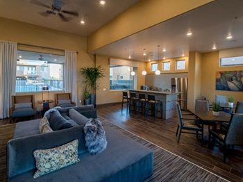 A living room with a couch a table and chairs
