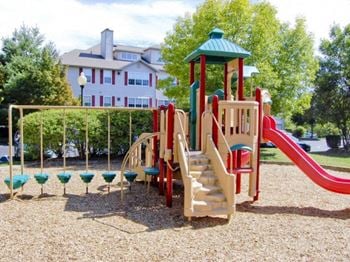 A playground with a slide and monkey bars