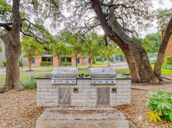 A grilling area in the middle of a park
