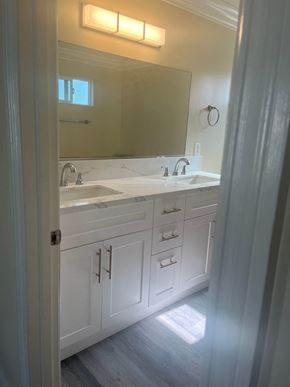 Hawthorne apartment for rent - a white bathroom with two sinks and a mirror