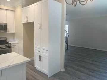 Hawthorne apartment for rent - a renovated kitchen and living room with white cabinets