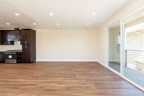 Hawthorne apartment for rent - a living room with a hardwood floor and a sliding glass door