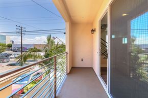 Hawthorne apartment for rent - a balcony with a view of the street and palm trees