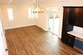 Hawthorne apartment for rent - A kitchen area with wooden floors and a chandelier.