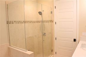 Hawthorne apartment for rent - A white bathroom with a glass shower door.