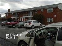 Middletown apartment for rent - a car parked in a parking lot in front of a building