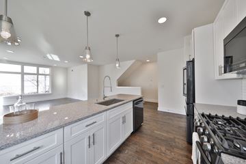 Philadelphia apartment for rent - a kitchen with white cabinets and a sink and a refrigerator