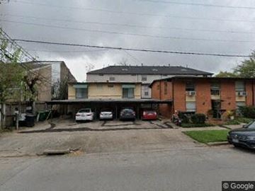 Houston apartment for rent - A cloudy day in a residential area with houses and cars.
