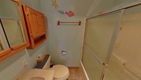 Sitka house for rent - a bathroom with a shower and a toilet and a sink