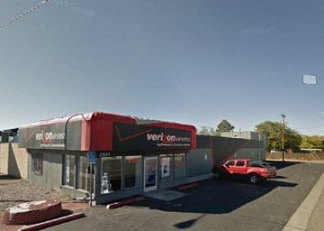 Albuquerque apartment for rent - A Verizon store with a red truck parked in front.