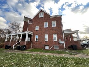 Dravosburg apartment for rent - A red brick house with a white door and windows.