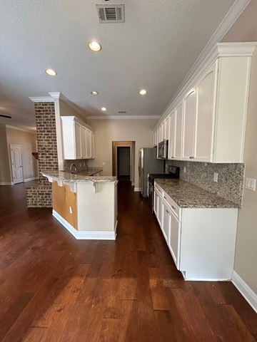 Crestview house for rent - A kitchen with white cabinets and a granite countertop.