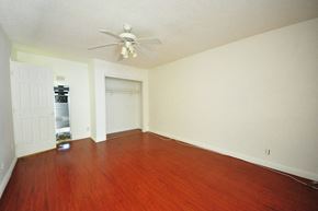 Pomona apartment for rent - an empty living room with wood floors and a ceiling fan