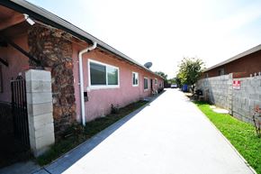 Pomona apartment for rent - an empty sidewalk in front of a brick building