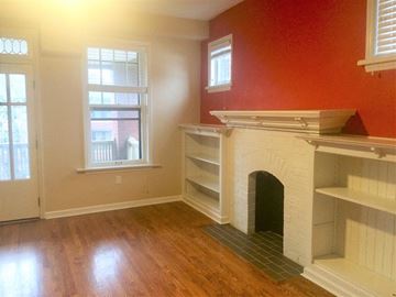 Saint Loui apartment for rent - a living room with a fireplace and a wooden floor