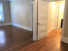 Saint Louis apartment for rent - an empty room with an open door and wood floors