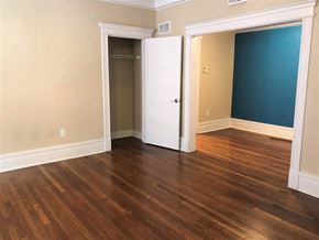 Saint Louis apartment for rent - an empty living room with wood floors and a closet