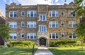 Saint Louis apartment for rent - A large brick building with a gate in front.