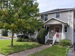 Ottawa house for rent - A house with a red door and white railings.