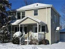 Ottawa house for rent - A house with a snow-covered front yard.
