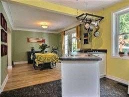 Ottawa house for rent - A kitchen with yellow walls and a white island.