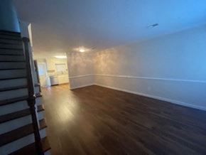 Wilson apartment for rent - A room with wooden floors and white walls.