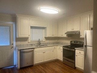 Wilson apartment for rent - A kitchen with white cabinets and a wooden floor.