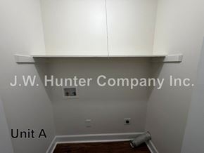 Wilson apartment for rent - A room with a white ceiling and a white wall with a J.W. Hunter Company Inc. sign.