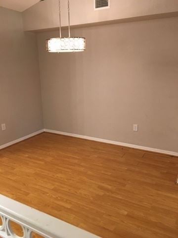 Tampa house for rent - a living room with a wood floor and a chandelier