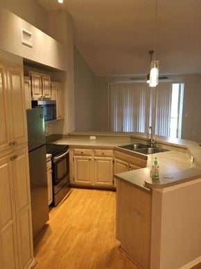 Tampa house for rent - an empty kitchen with a refrigerator and a sink