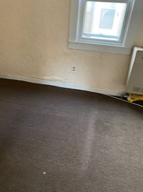Buffalo apartment for rent - a room with a carpeted floor and a window