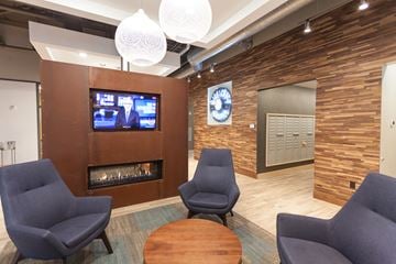 Minneapolis apartment for rent - a living room with a fireplace and chairs and a table