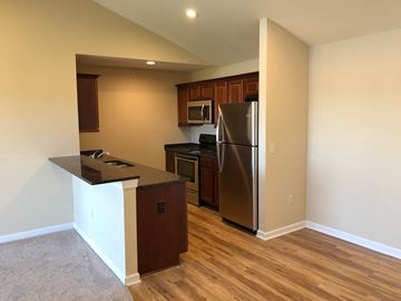 Hornell apartment for rent - A kitchen with a refrigerator, oven, and microwave.
