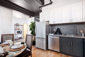 Brooklyn apartment for rent - a kitchen with stainless steel appliances and a dining table
